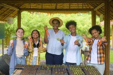 Group of mixed race students and teacher learning agriculture  technology in smart farming ,...