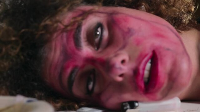 young woman brutalized by drugs with her head resting on the table