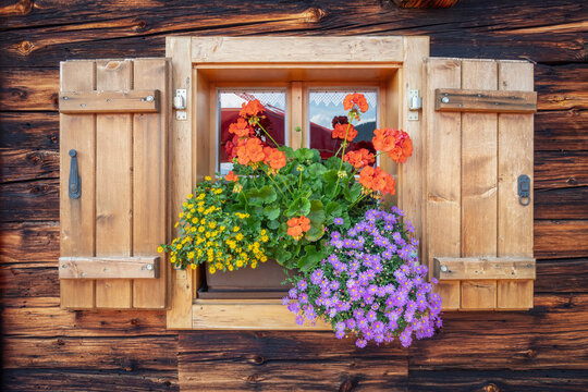 Decorative window of a wooden cabin in the alps