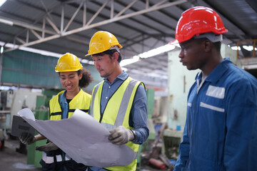 Three Heavy Industry Engineers Stand in Pipe Manufacturing Factory, Use Digital Tablet Computer, Have Discussion. Design and Construction