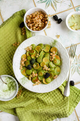 Green mini matcha pancakes in a white plate on a table with a tablecloth. Beautiful morning...