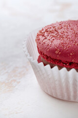 Fresh red macarons. Extreme shallow depth of field with selective focus, large sugar crystals are visible.