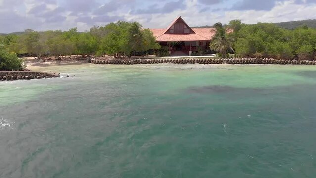 Flying over a caribbean house in a tropical beach of Baru, Islas del Rosario, Cartagena, Colombia