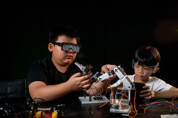 Elementary school students work on a robotics repair project in the classroom.