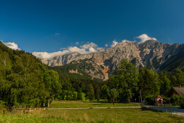 Fototapeta na wymiar Big rock stone hills over Bovec village in Slovenia mountains near Soca river