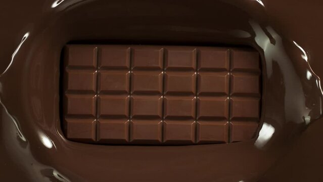 Super Slow Motion of Falling Chocolate Bar into Melted Chocolate. Filmed with High Speed Cinema Camera, 1000fps.
