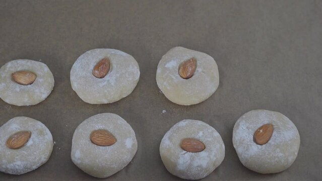 Spread raw cookies on a baking sheet to bake them. The process of making gluten-free almond flour cookies. Step by step. Homemade baking cookies. Biscotti di mandorla siciliani.