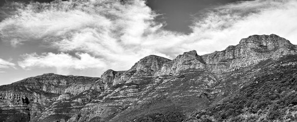 Black and white landscape of mountains on a cloudy sky background with copy space. Nature view of popular landmark, Twelve Apostles mountain, in tourism hiking location, Cape Town, South Africa