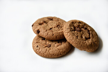 Fototapeta na wymiar Oatmeal cookies with chocolate chips on a white background. Cookies are delicious close-up.