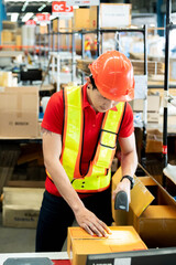 Worker Scanning Package In Warehouse for shipping at warehouse factory.