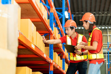 Man worker hold clipboard document talking to woman in warehouse store. Male and female engineers people wear safety hard helmet and vest  checking storage box parcel in factory
