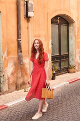 Woman enjoying of the old bricked town during the warm summer morning