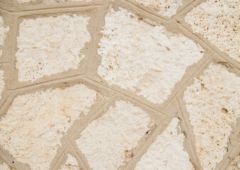 The texture of the stone is beige.Rock, decorative stone. Rough texture of the stone.