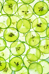 Fototapeta premium Macro Lime,Lemon and green lime overlapped slices close-up background,Macro lemon texture,Macro close up surface texture Juicy slice of lime