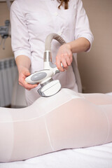 A woman having anti cellulite massag treatment at beauty spa salon.