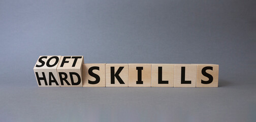 Soft Skills and Hard Skills symbol. Turned cubes with words Soft Skills and Hard Skills. Beautiful grey background. Businessman hand. Business concept. Copy space