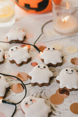 Fototapeta na wymiar Funny scary Halloween ghost cookies on white wooden background.