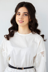 Beauty front portrait of a beautiful smiling young woman wear white shirt, posing in a studio, isolated white background.