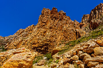 Towering vertical rock strata in deep valley