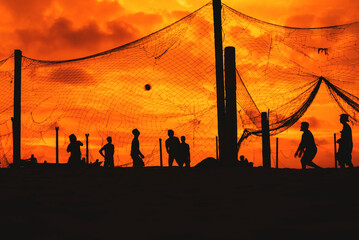 Volleyball on the beach at sunset