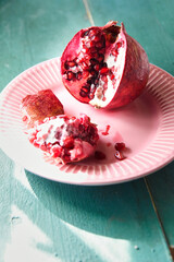 Red pomegranate and blue wooden background