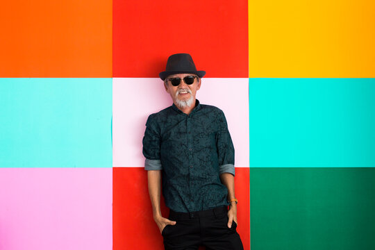 Portrait of senior man colorful background, retirement