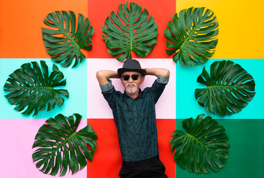 Portrait of senior man colorful background, retirement