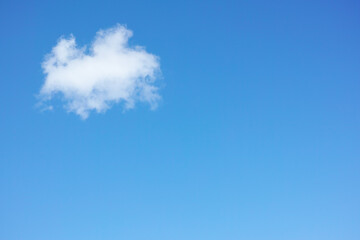 Copy space with cumulus clouds in a clear blue sky from below. Beautiful panoramic of fluffy white cloudscape background for cool climate and season of sunny weather in the atmosphere outdoors