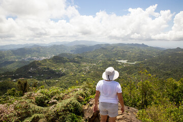 Naklejka premium Woman Hiking Mountain Top in Puerto Rico. Great View from Mountain Peak. Outdoor Travel Adventure.