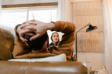 Couple Sitting on Couch Arguing During a Breakup