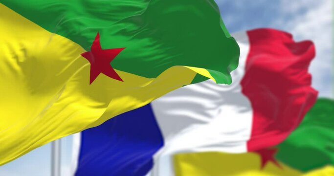 National flags of French Guiana waving with the flag of France on a clear day