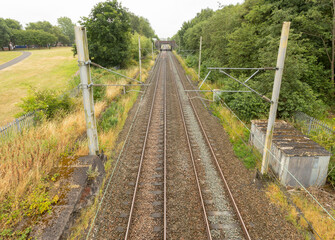 Fototapeta premium train tracks at longport station going of to the distance towards stoke on trent showing the Overhead line equipment shot from above
