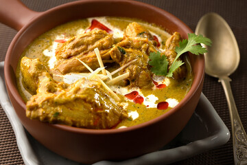 Butter chicken korma served in dish isolated on dark background side view