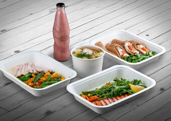 A set of healthy food dishes in ecological packaging on a wooden background. Food delivery. Takeaway.