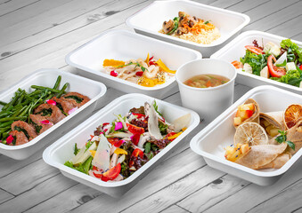 A set of healthy food dishes in ecological packaging on a wooden background. Food delivery. Takeaway.