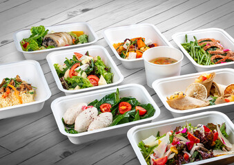 A set of healthy food dishes in ecological packaging on a wooden background. Food delivery. Takeaway.