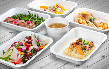 A set of healthy food dishes in ecological packaging on a wooden background. Food delivery. Takeaway.