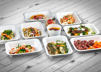 A set of healthy food dishes in ecological packaging on a wooden background. Food delivery. Takeaway.