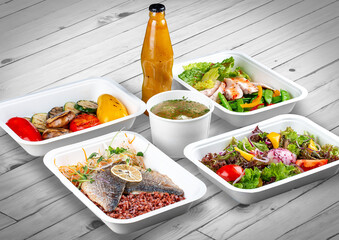 A set of healthy food dishes in ecological packaging on a wooden background. Food delivery. Takeaway.