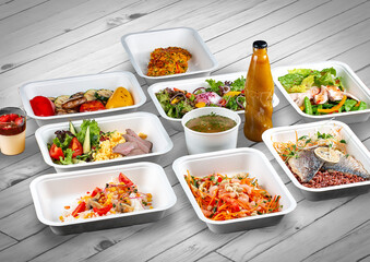 A set of healthy food dishes in ecological packaging on a wooden background. Food delivery. Takeaway.