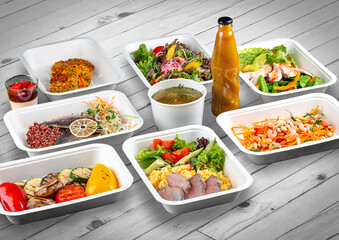 A set of healthy food dishes in ecological packaging on a wooden background. Food delivery. Takeaway.