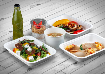A set of healthy food dishes in ecological packaging on a wooden background. Food delivery. Takeaway.