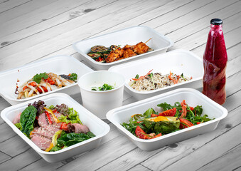 A set of healthy food dishes in ecological packaging on a wooden background. Food delivery. Takeaway.