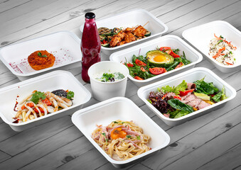 A set of healthy food dishes in ecological packaging on a wooden background. Food delivery. Takeaway.