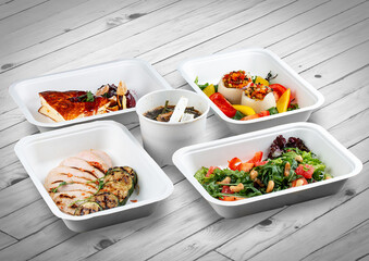 A set of healthy food dishes in ecological packaging on a wooden background. Food delivery. Takeaway.
