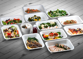 A set of healthy food dishes in ecological packaging on a wooden background. Food delivery. Takeaway.