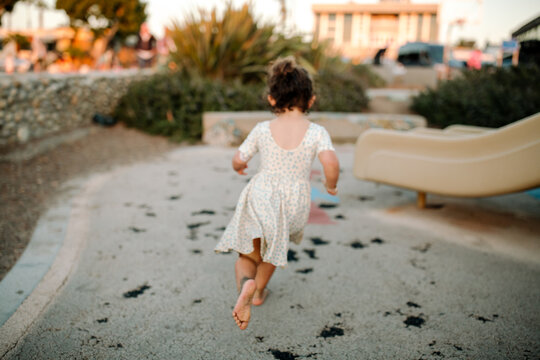 Back of girl running at playground