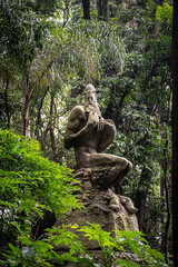 statue in the middle of tropical forest