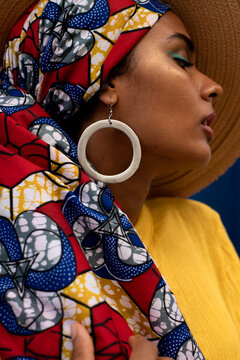 Close portrait with round earring and african print scarf
