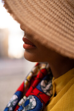 Detail of the lips with straw hat